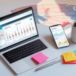Flat lay of a laptop and smartphone showing blog analytics with a coffee cup and notepad on a white desk, representing blog strategy and marketing for the USA market.